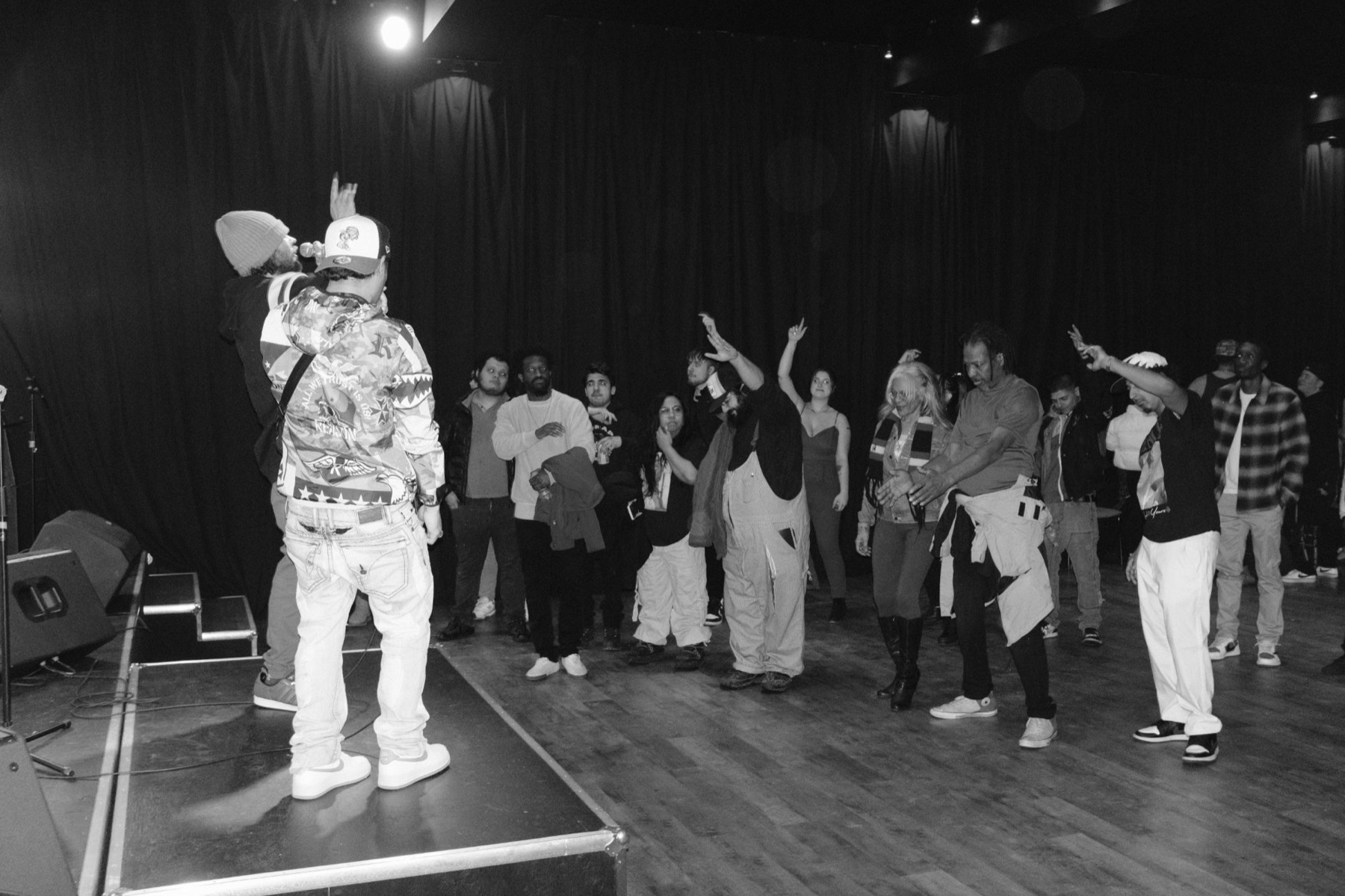 Performers on stage with the crowd at an Only da Soul show